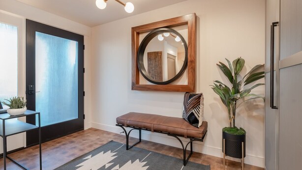 A modern entryway with a bench, a mirror, a potted plant, and a door with frosted glass. - Modern Lakefront Condo F1 + Pool - Wapato Chelan (Manson)