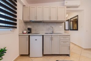 Family Suite, Balcony, Partial Sea View | Private kitchen | Shared microwave, highchair, cookware/dishes/utensils, freezer