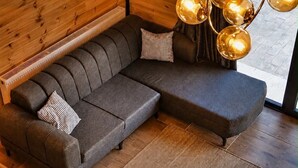 Un interior moderno con un sofá modular, un tapete estampado y una lámpara esférica original.
