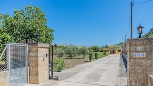 A gated entrance to a property with a clear sky, a lamp post, and a sign reading 'RAFAL'. - Pollensa Mountain View Villa (Pollença)