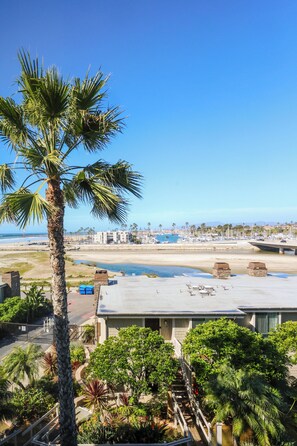 A coastal hotel with a view of the beach and ocean. - Harbor and Ocean View Coastal Retreat Walk to Beach & Marina (Oceanside)