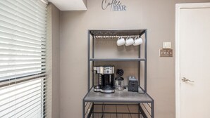 A kitchenette with a coffee machine, a toaster, and a mug rack. - Wooded Retreat Minutes from DFW Airport (Flower Mound)
