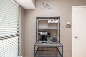 A kitchenette with a coffee machine, a toaster, and a mug rack. - Wooded Retreat Minutes from DFW Airport (Flower Mound)
