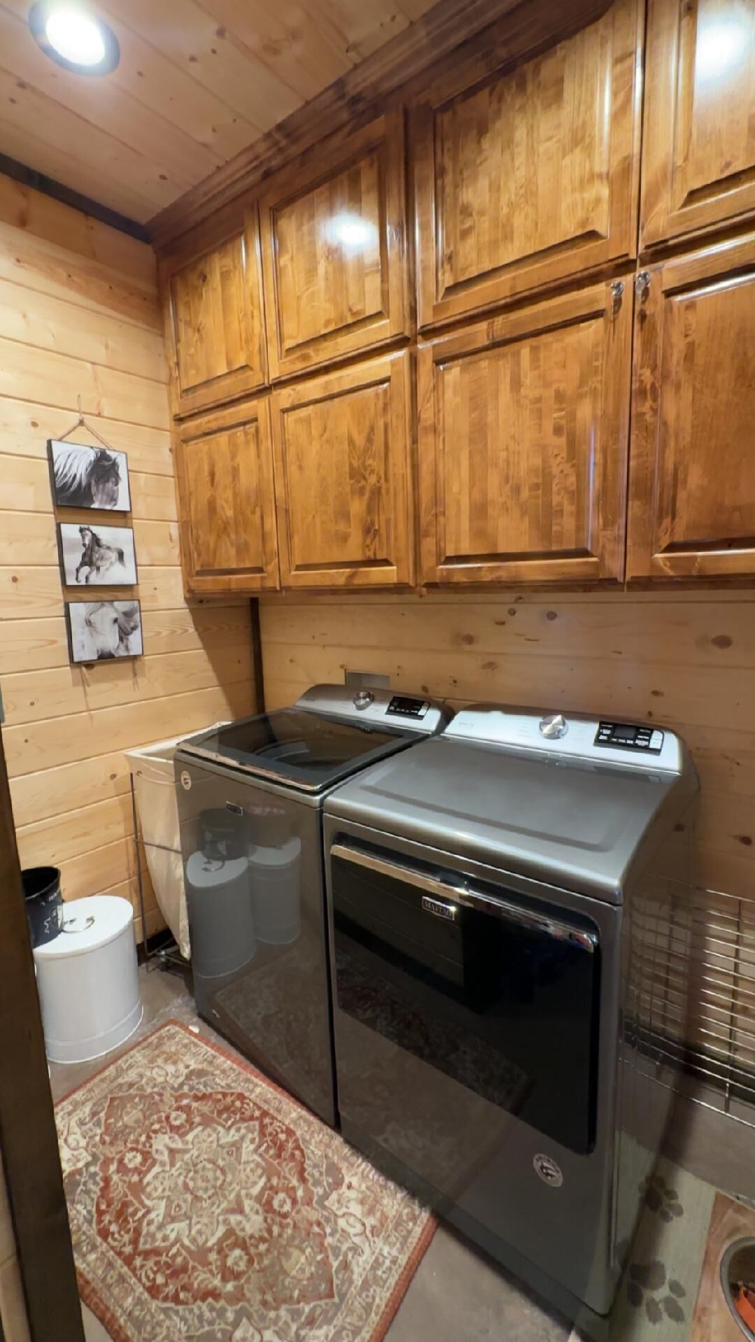 A kitchen with wooden cabinets, a stove, and a refrigerator.