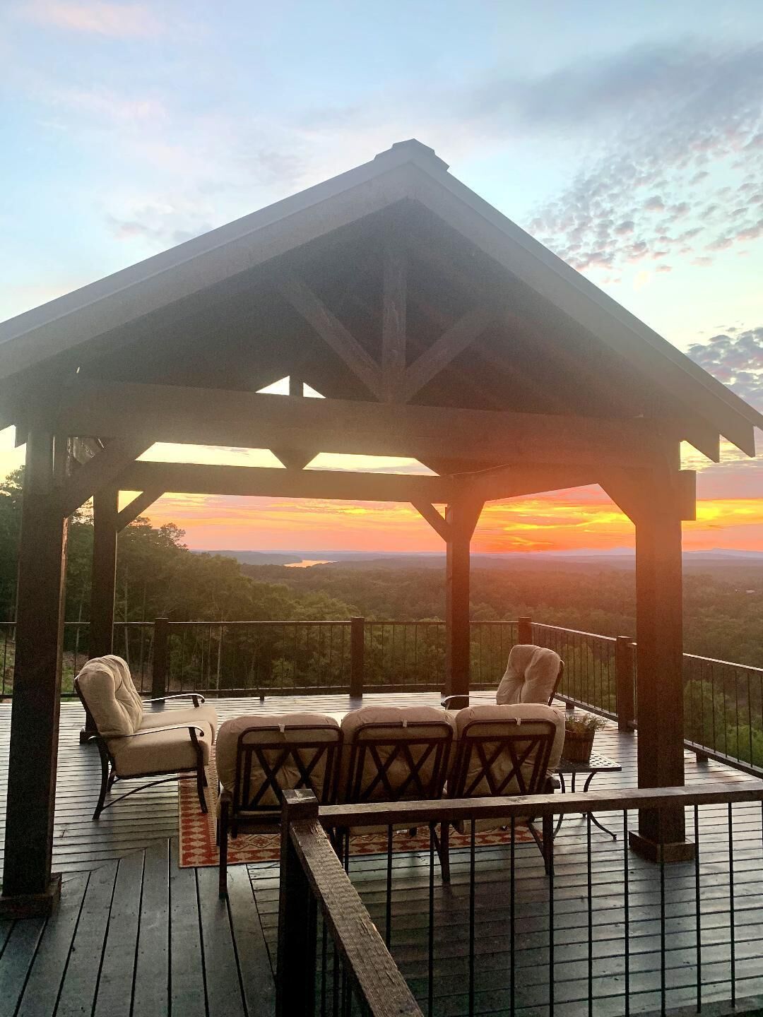 A covered outdoor seating area with a view of the landscape.