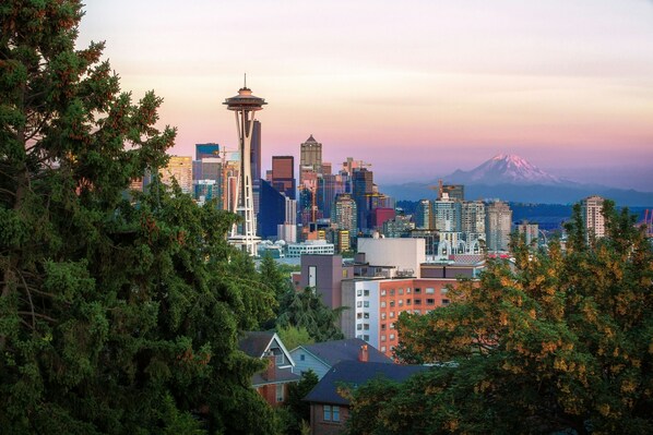 A cityscape with a prominent tower and a mountain in the background.