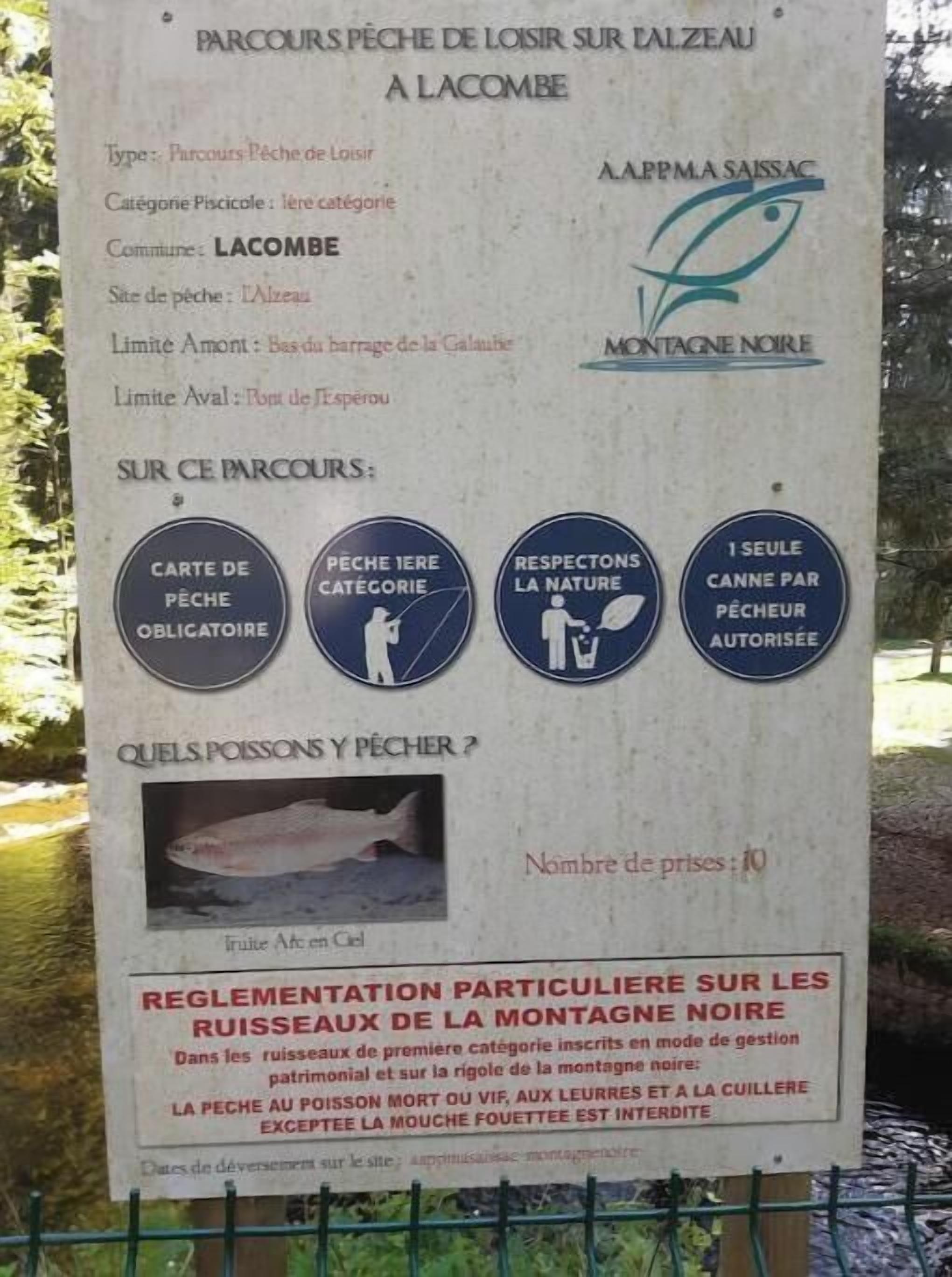 A sign with information about fishing regulations and fees at Lacombe.