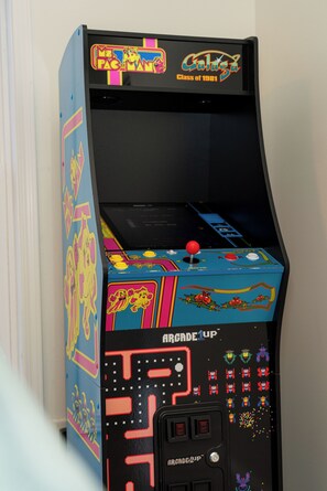 A vintage arcade machine with colorful graphics and a joystick.