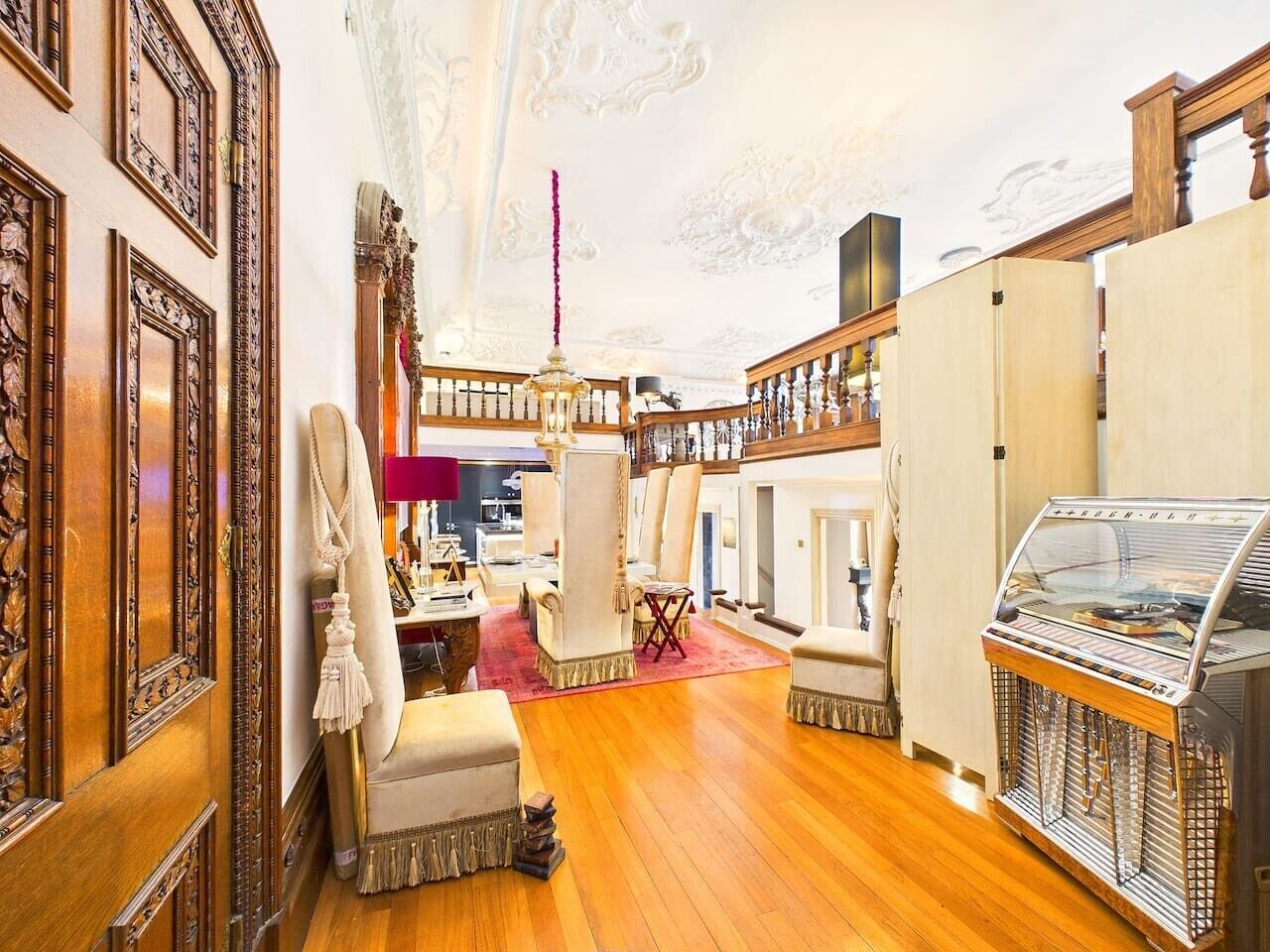A luxurious interior with ornate wood paneling, a grand chandelier, and a vintage ice cream parlor.