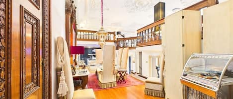 A luxurious interior with ornate wood paneling, a grand chandelier, and a vintage ice cream parlor.