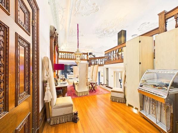 A luxurious interior with ornate wood paneling, a grand chandelier, and a vintage ice cream parlor.