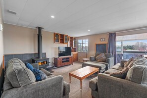 A living room with a fireplace, a television, and a sofa.