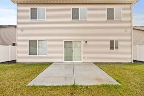 A two-story residential building with a front door, two windows on the ground floor, and a small porch area. - Cheney Home | Close to Interstate & Airport (Cheney)