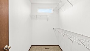 A small, white-walled closet with a skylight, a door, and a carpeted floor. - Cheney Home | Close to Interstate & Airport (Cheney)