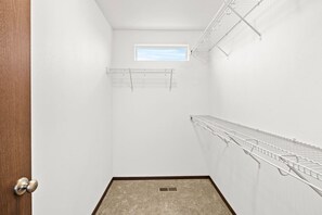 A small, white-walled closet with a skylight, a door, and a carpeted floor. - Cheney Home | Close to Interstate & Airport (Cheney)
