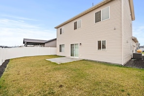 A two-story building with a fenced backyard, a covered patio, and a small garden area. - Cheney Home | Close to Interstate & Airport (Cheney)