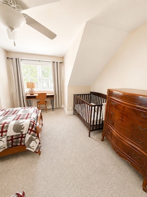A bedroom with a bed, a desk, a chair, a crib, and a dresser. - Sebago Lake Estate, 300’ Frontage, Inside the State Park, Private Dock & Kayaks (Casco)