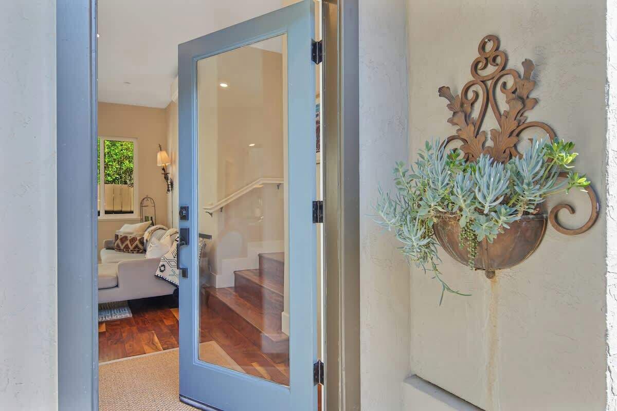 A doorway leading to a living area with a sofa and a lamp.