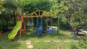 A playground with a slide, swings, and a climbing structure.