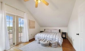 A bedroom with a bed, a ceiling fan, a window with curtains, and a view of the outdoors. - Wrap-around deck, cozy home, gateway to the Canyon. (Williams)