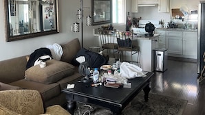 A living room with a ceiling fan, a dining area with chairs, a kitchen with cabinets, and a patterned rug. - Fabulous 2-bedroom apartment in sunny San Clemente perfect for relaxing (San Clemente)