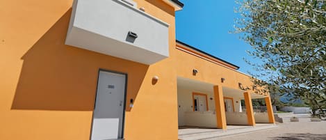 A building with a series of balconies and a door labeled 'Lodging'.