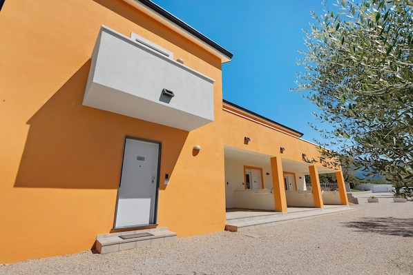 A building with a series of balconies and a door labeled 'Lodging'.