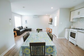 A modern kitchen with white cabinets, a gas stove, and an oven. - Sandpiper Cottage - 3-Bedroom Cottage – Family Friendly (Trent Lakes)
