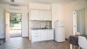 A compact kitchen with white cabinets, a built-in sink, and a refrigerator. - Oliblu Holiday Home – Superior Taggiasca Apartment with Partial Sea View (Vibonati)