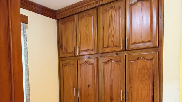 Ein Schrank aus Holz mit mehreren Türen und Schubladen.
