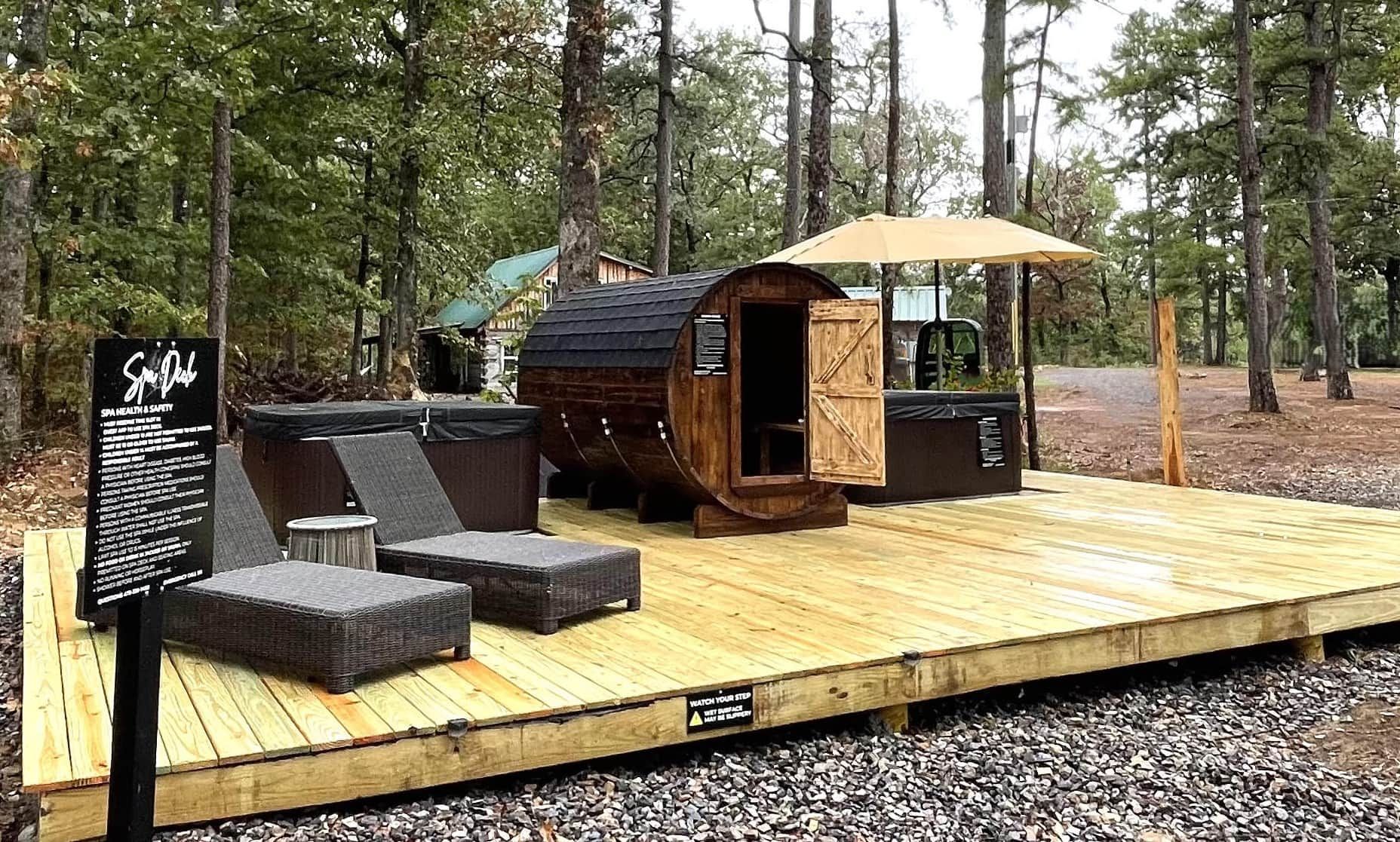 A wooden deck with outdoor seating, a covered area, and a spa sign.