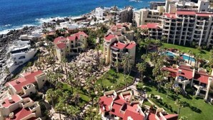 A coastal resort with multiple buildings, a beach, and a view of the ocean. - Peaceful 2BR/2BA condo with Wrap-Around patio that overlooks the Sea of Cortez. (Cabo San Lucas)