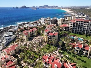 A coastal resort with multiple buildings, a beach, and a view of the ocean. - Peaceful 2BR/2BA condo with Wrap-Around patio that overlooks the Sea of Cortez. (Cabo San Lucas)