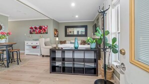 A modern living room with a sofa, coffee table, and a dining area with a table and chairs. - Stunning 2-bed Apt in the Heart of Queen Anne (Seattle)