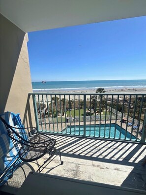 A balcony with a view of a beach and a swimming pool. - Oceanfront Coastal Comfort - Unique and Beautiful
Sand Dunes Resort (Myrtle Beach)