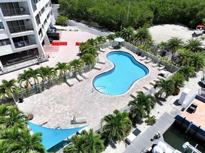 An aerial view of a resort with a swimming pool, palm trees, and a beach area. - New Key Largo Kawama . 2 Kings . Matina . Pickleball (Key Largo)