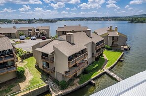 A lakeside residential area with multiple two-story buildings, each featuring balconies and a small lawn. - 2-bedroom condo in perfect Hot Springs with cool AC (Hot Springs)
