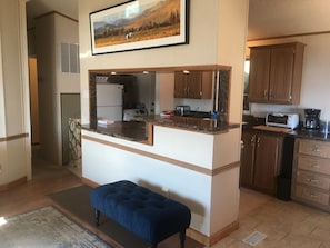 A kitchen with a marble countertop, wooden cabinets, a built-in oven, and a microwave. - Cozy 2-bedroom cabin Wofford Heights, with hot tub/AC/sauna (Wofford Heights)