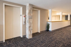 A hotel corridor with a reception desk, a stone pillar, and a door marked with the number 3. - ML 354 - Dazzling mountain views await you! Renovated bike-in/out retreat! (Snowshoe)