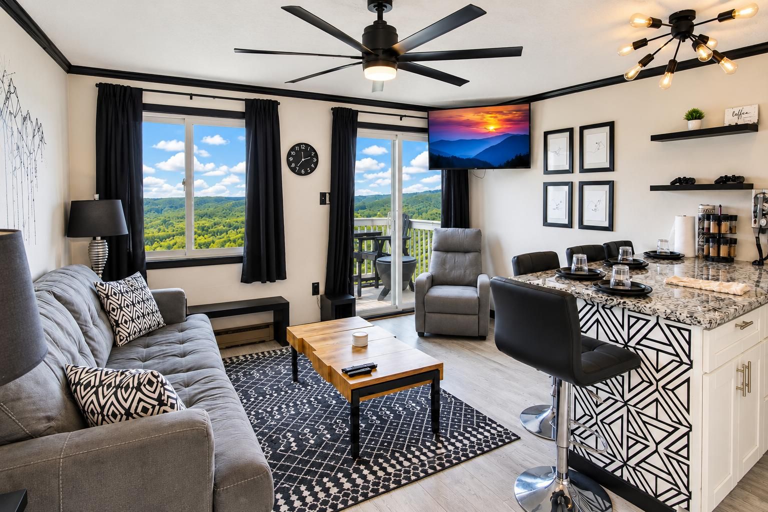 Un salon moderne avec un canapé, une table basse et un téléviseur. Il y a un balcon avec vue, un coin repas avec des chaises et une cuisine avec un bar.