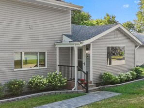 A two-story house with a covered porch and a small attached garage. - My Happy Place! "RoundWeGoToo" (Machesney Park)