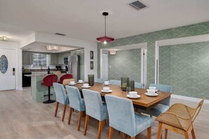 A modern kitchen with a dining area.