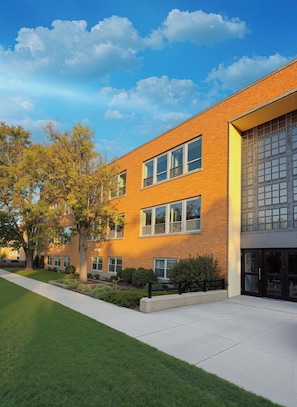 A multi-story building with a brick facade, large windows, and a well-maintained lawn. - Luxurious Brand New 3BR Walk D.T Brookfield (Brookfield)