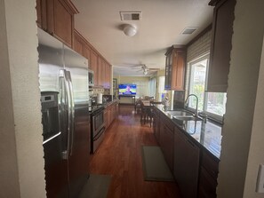A kitchen with wooden cabinets, a stainless steel refrigerator, a microwave, and a built-in oven. - Perfect two story home 4BR, 2.5 Bath in the heart of Rancho Penasquitos. (San Diego)