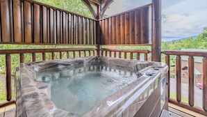 A hot tub on a wooden deck with a view of a forested landscape. - Near Downtown Gburg, Theater, Views, Trailer Parking,Dogs OK! (Gatlinburg)