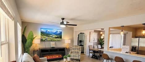 A modern living room with a sofa, coffee table, and a flat-screen TV.