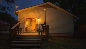 A house with a porch, steps, and string lights. - Montview cottage  Walk to Burnet Rd, Central ATX (Austin)