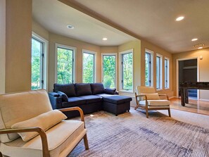 A spacious living room with a sectional sofa, a chaise lounge, and a wooden coffee table. - Shenandoah Sky House - walk to Lake Laura trail! + fire pit (Basye)