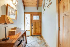 A wooden interior with a desk, lamp, and a door with a window. - 4 Virginia Rail - Dog-Friendly Sunriver Home with A/C, Hot Tub & SHARC Passes (Sunriver)