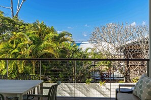 A balcony with a view of a building and a tree. - Alex Headland Haven - 3 Level Modern Retreat (Mooloolaba Region)